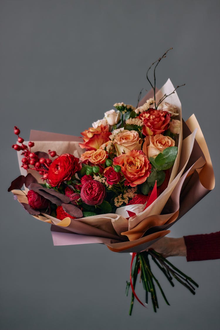 Hand Holding Large Bouquet Of Roses