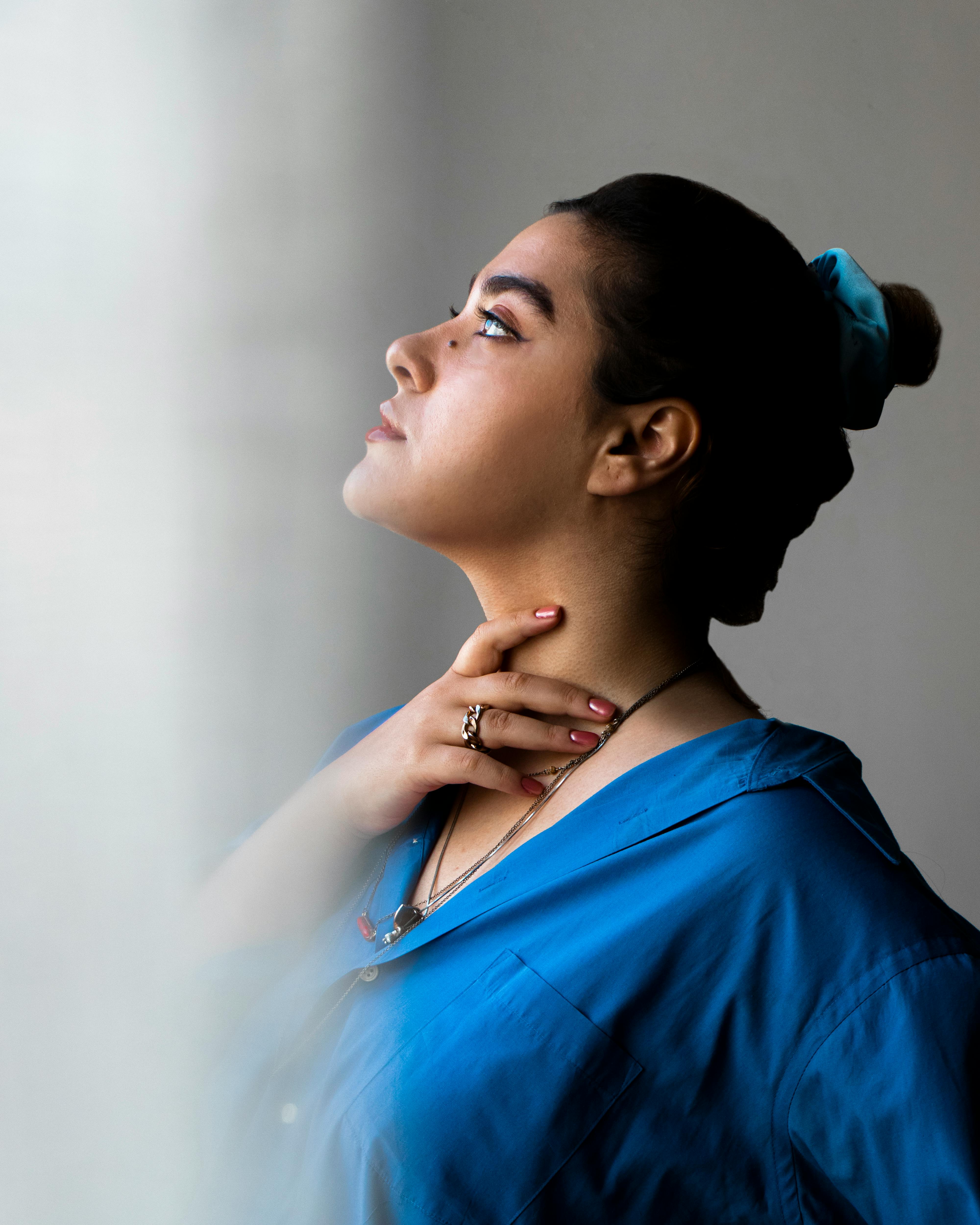 A Woman holding her Neck · Free Stock Photo