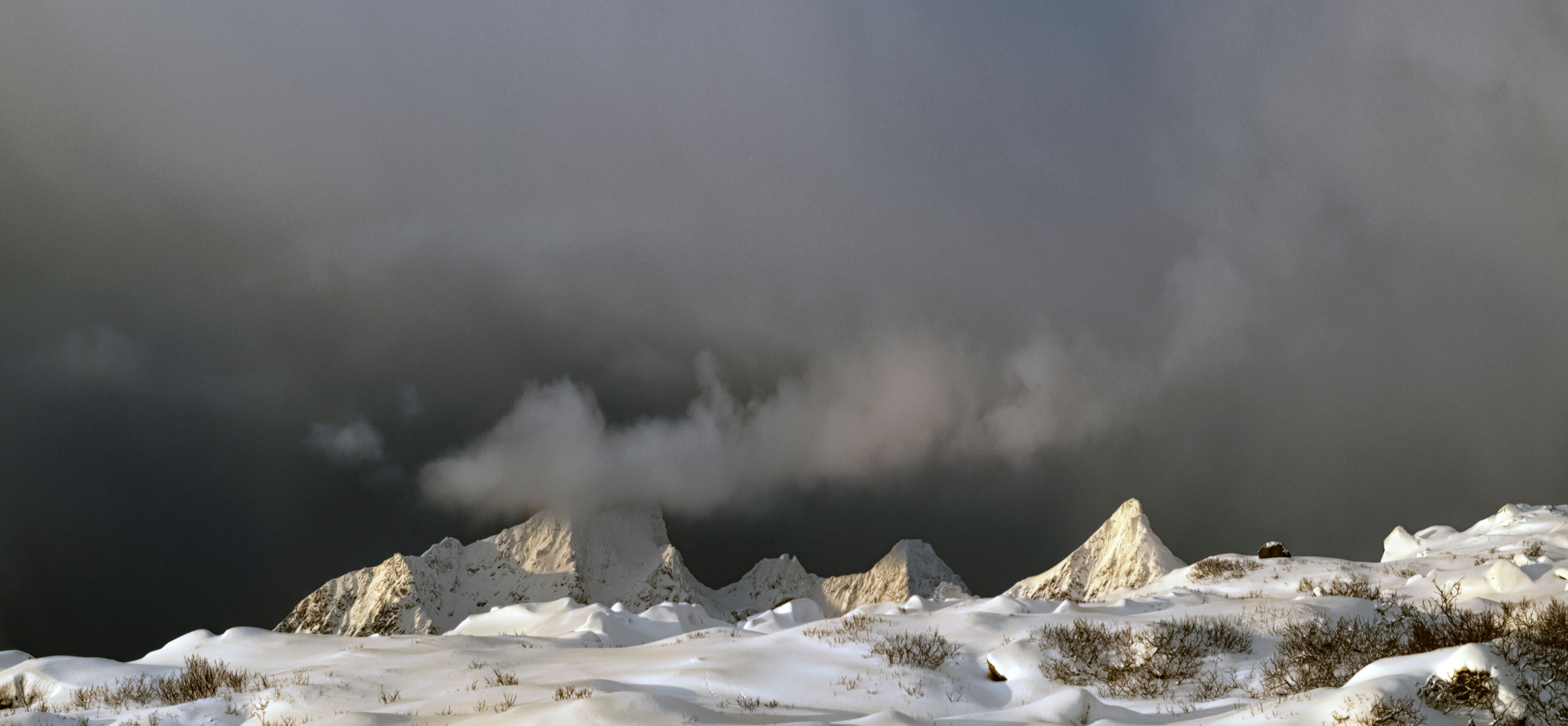 Dark Clouds over Snow Covered Mountains · Free Stock Photo