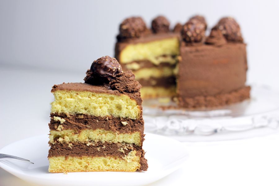 Sliced chocolate layer cake with a ganache topping