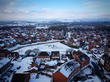 A snow-covered aerial view of Duffryn, Wales, showcasing the winter beauty of the neighborhood.