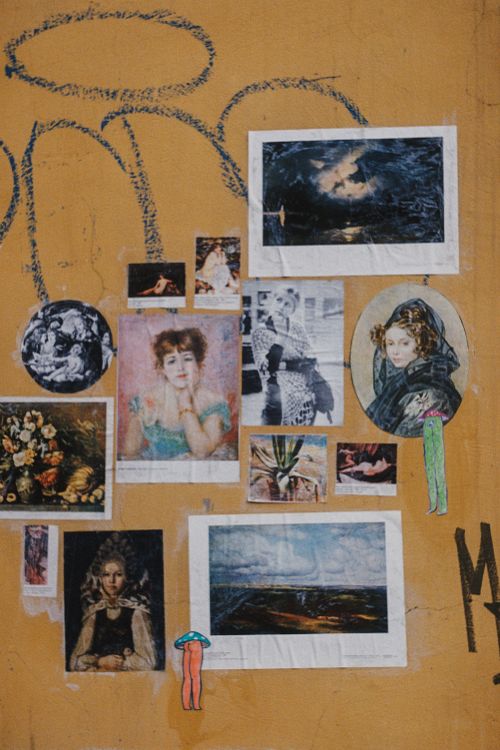 Free A vibrant collage featuring vintage artwork and creative designs on a textured wall. Stock Photo