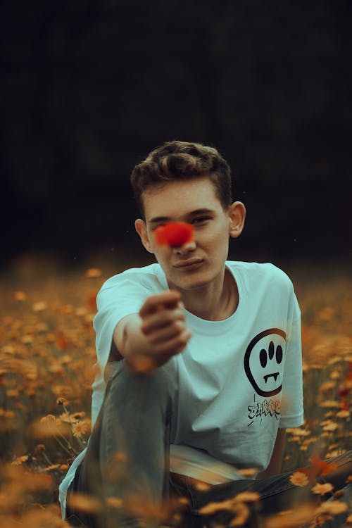 Man Holding a Red Flower