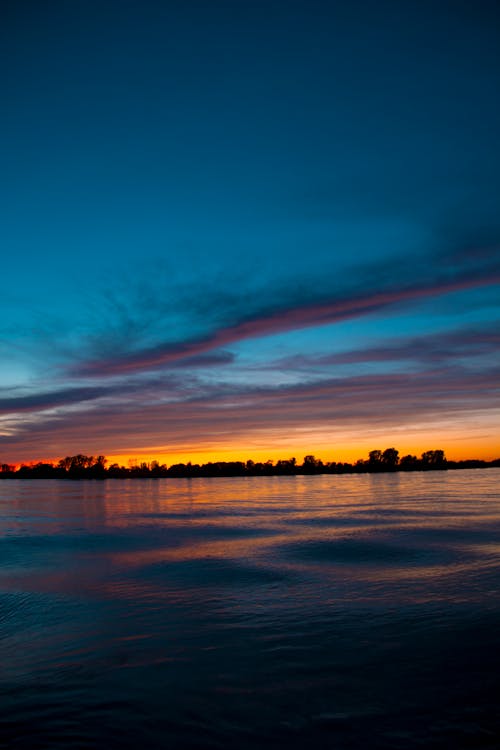 Photos gratuites de aube, ciel bleu, ciel orange