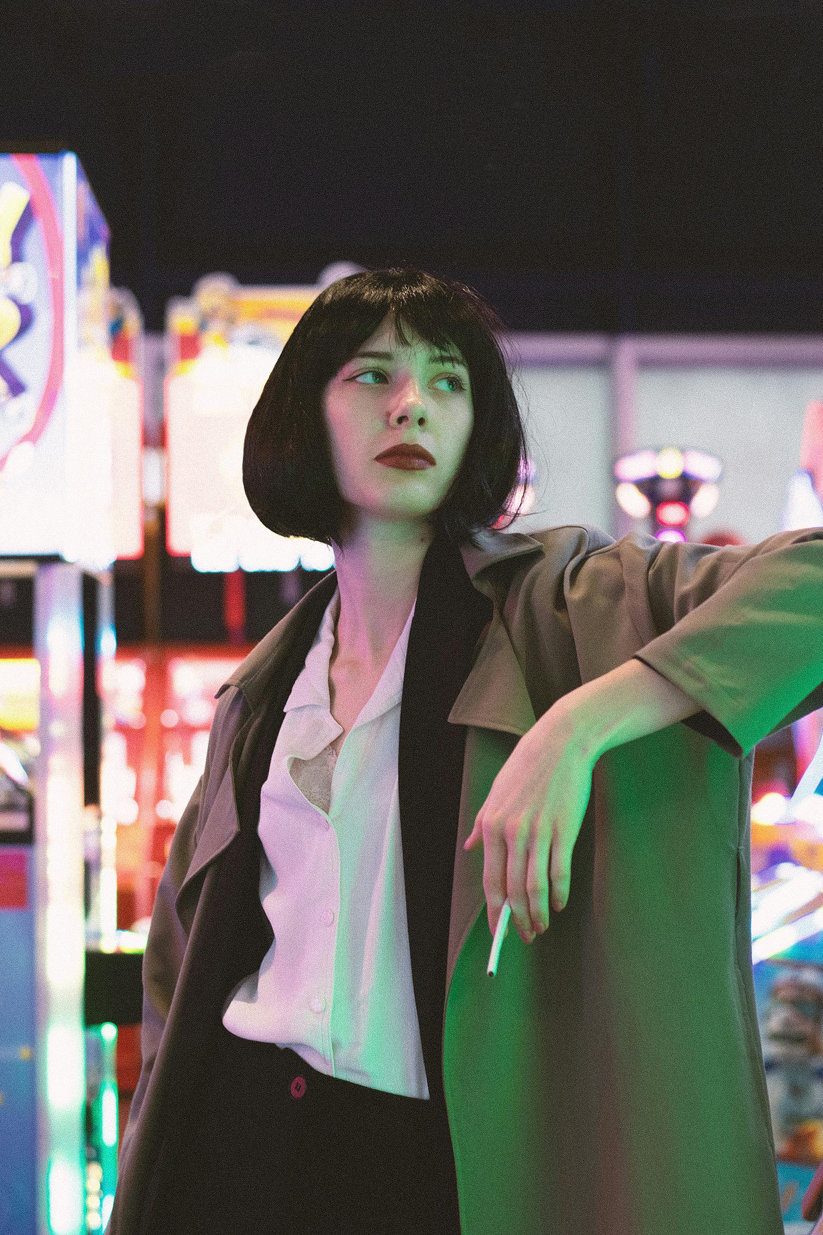 Chic portrait of a woman smoking in a vibrant, urban environment.