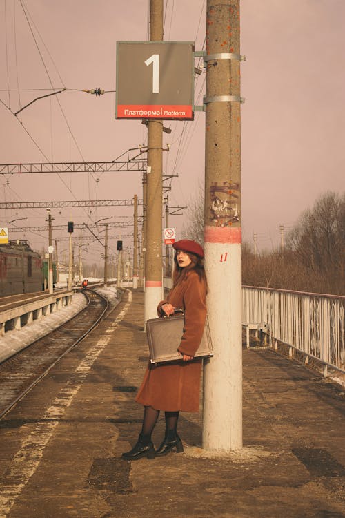 Woman with Suitcase on Railway Station