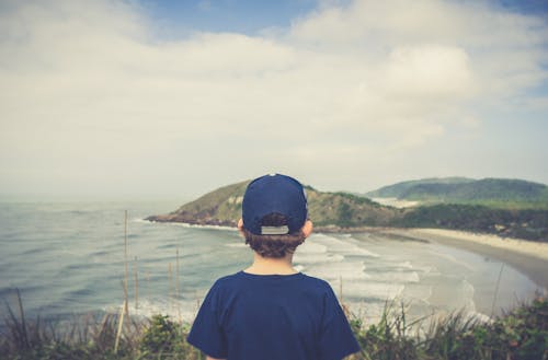 Boy Standing Near Cliff