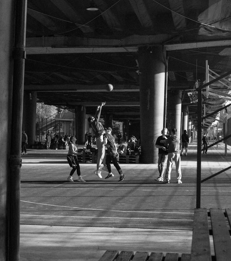 Grayscale Photo Of People Playing Basketball 