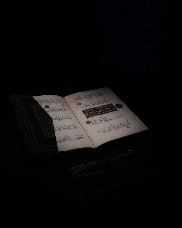 Open pages of the Quran with artistic calligraphy