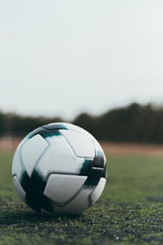 Close-up shot of a soccer ball on a grass field in Zapopan, Mexico, perfect for sports themes.