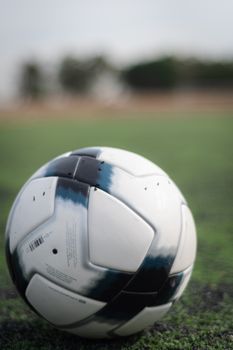 Detailed close-up of a soccer ball on a grass field in Zapopan, Mexico.