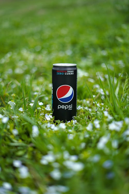 Free Pepsi Can on Green Grass Stock Photo