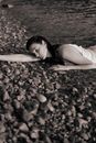 Woman Lying on Stony Beach