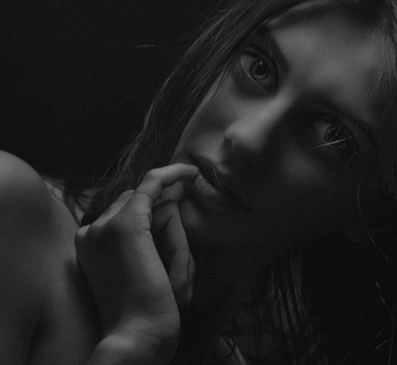 elegant monochrome close up portrait of a woman with hand on chin