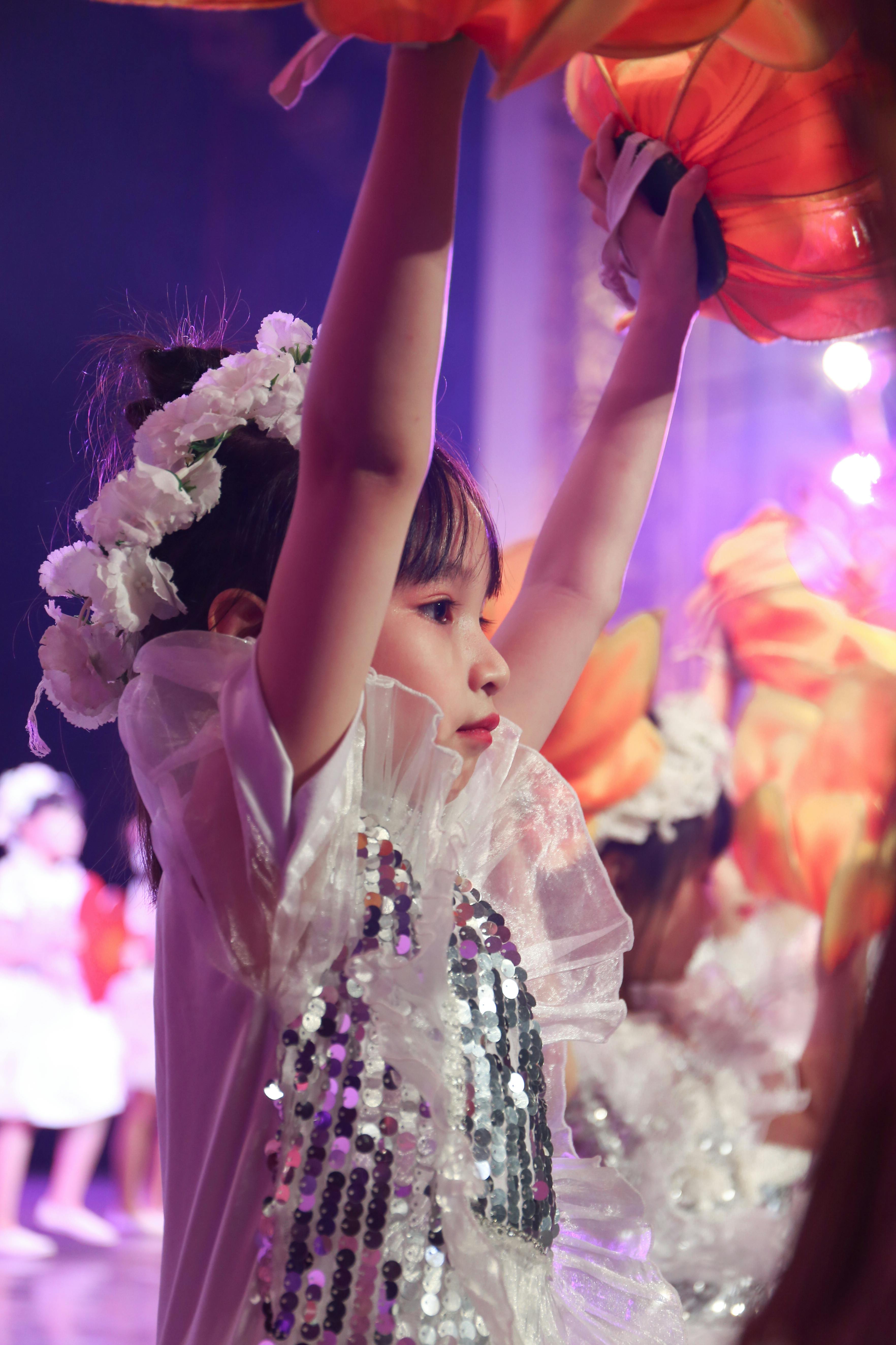 a girl in white dress dancing