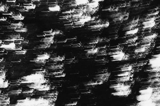 A striking abstract image featuring blurred white light streaks on a black background.