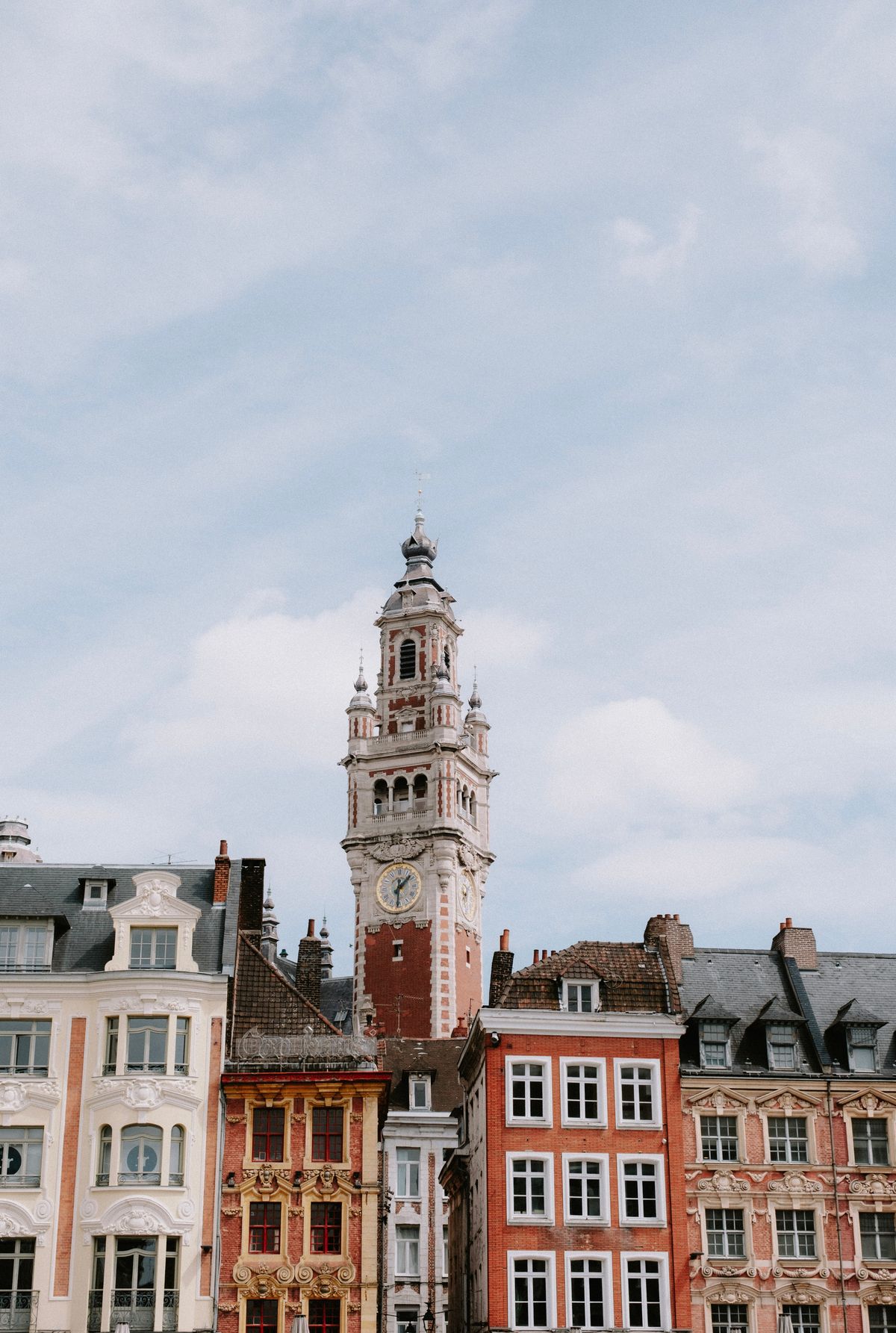 A belfry rising above colourful gabled rooftops in Lille