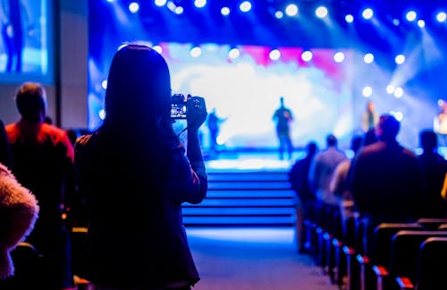 Silhouette of a Person Standing near the Stage