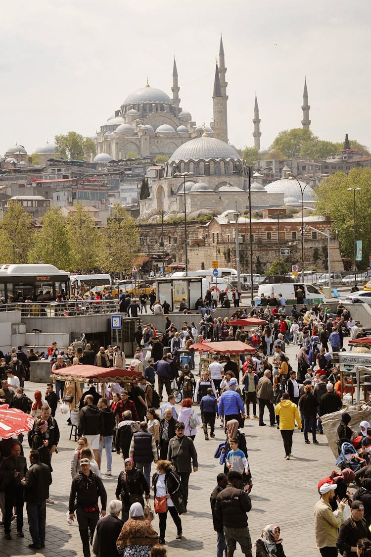 People Walking On Square Near Mosque