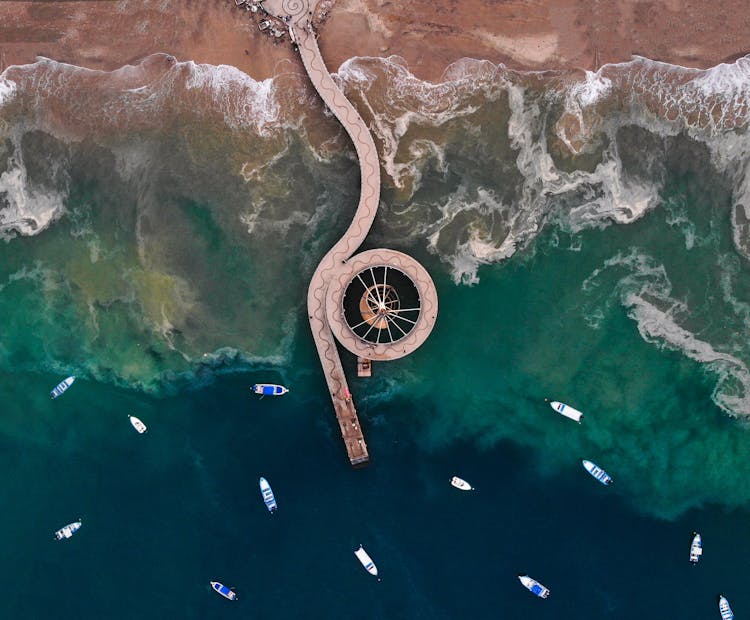 Long Curvy Pier In Sea