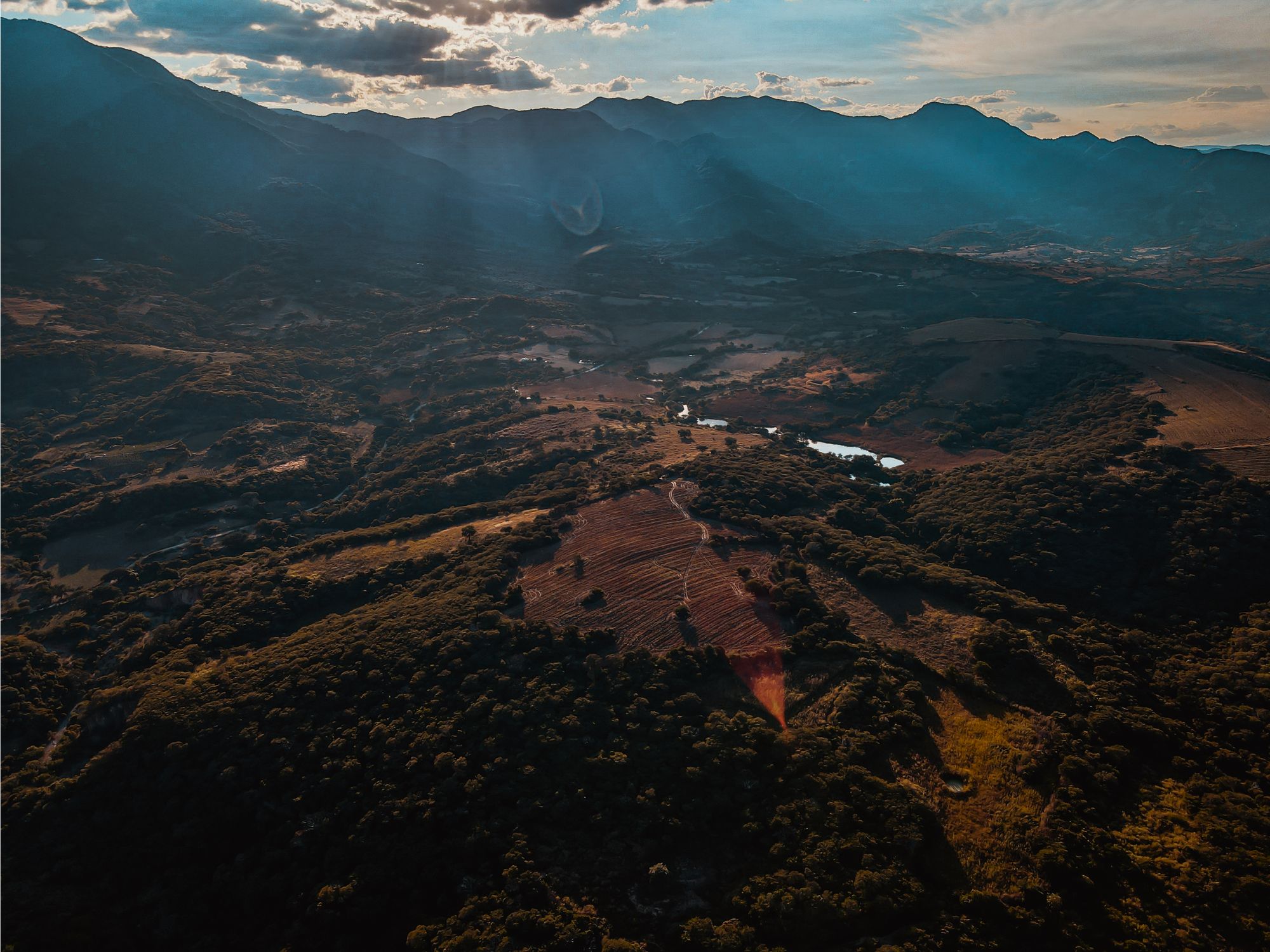 A stunning aerial view capturing the lush rural landscape and mountains of Tilzapotla, Mexico.