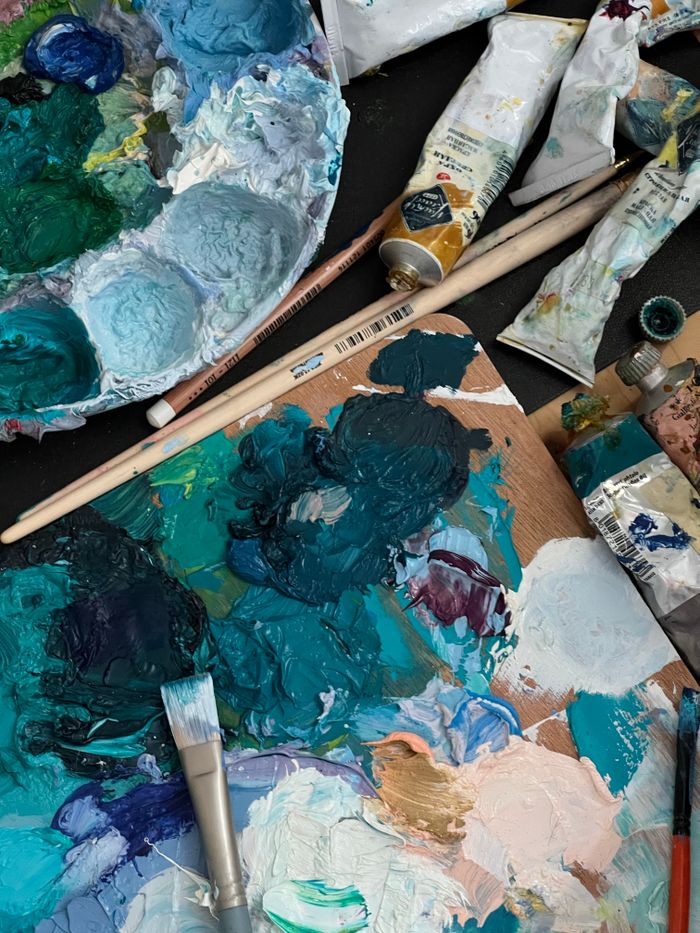 Colourful paint palette and brushes used for glass painting