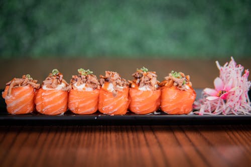 Mouthwatering Sushi on Black Rectangular Plate
