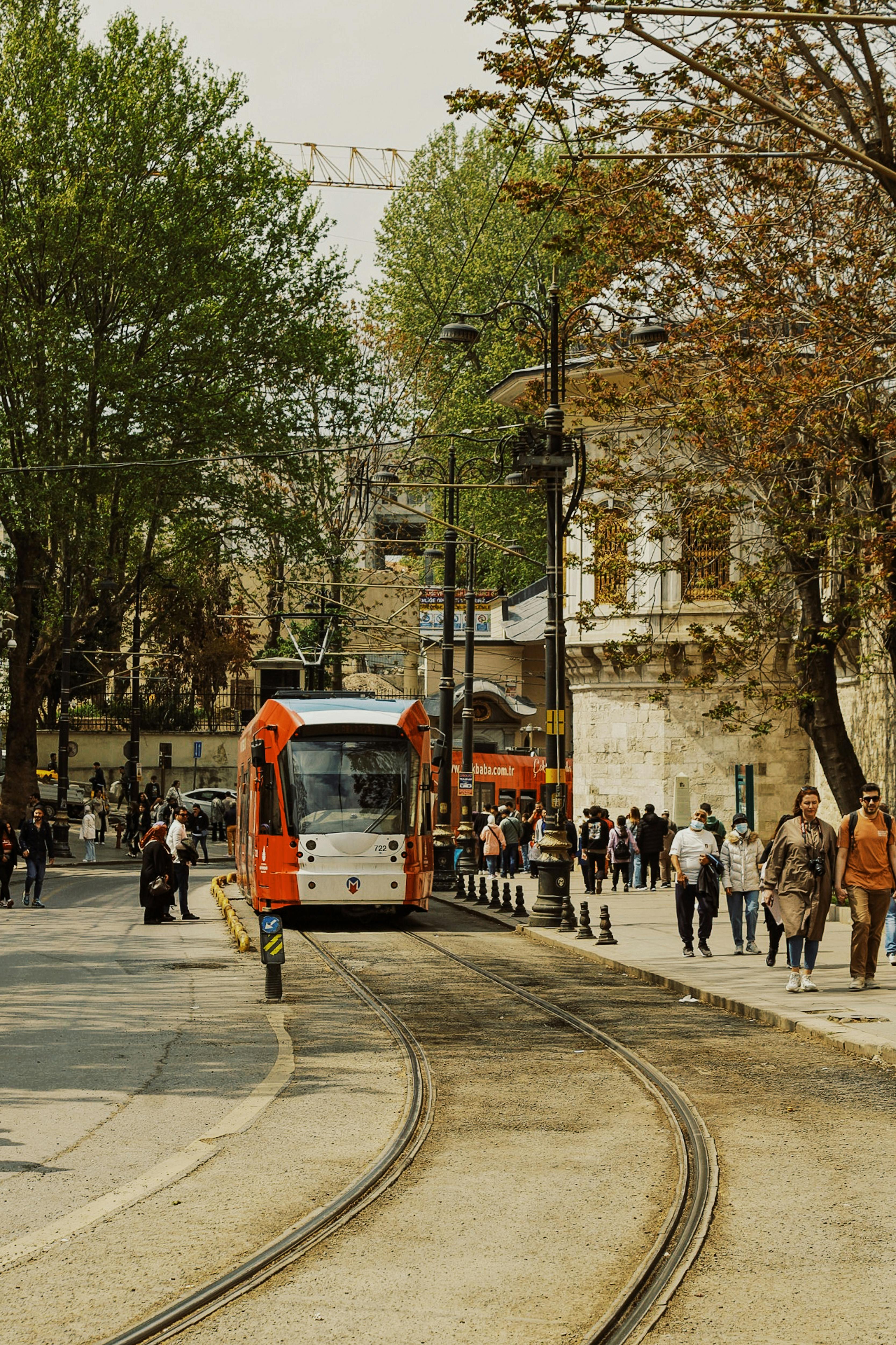 People Walking on the Sidewalk Near the Tramway