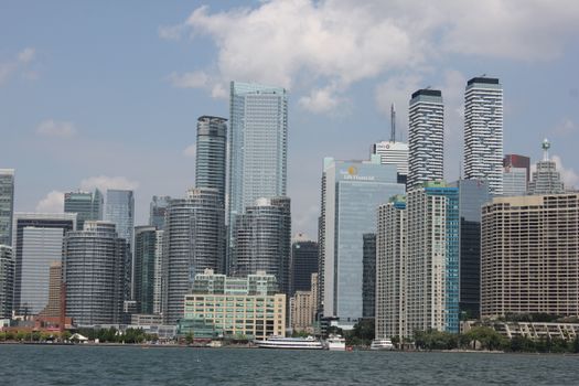 A striking view of Toronto's modern skyline with high-rise buildings by the waterfront.