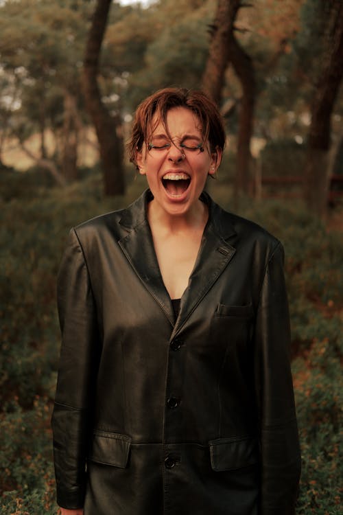 Woman in a Leather Jacket Standing Outdoors and Screaming 