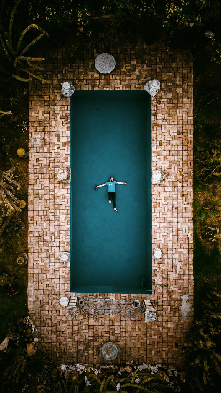 Top View Of Man Floating In The Pool 