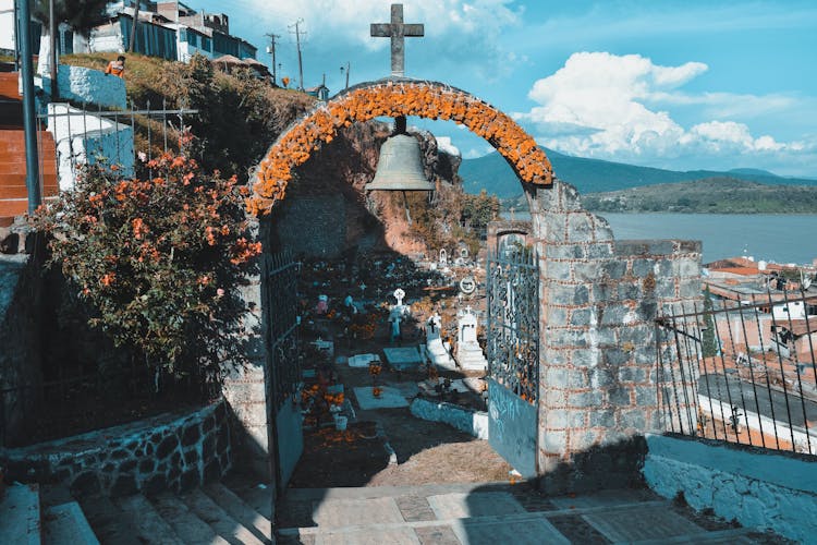 Cross And Bell Over Cemetery Gate