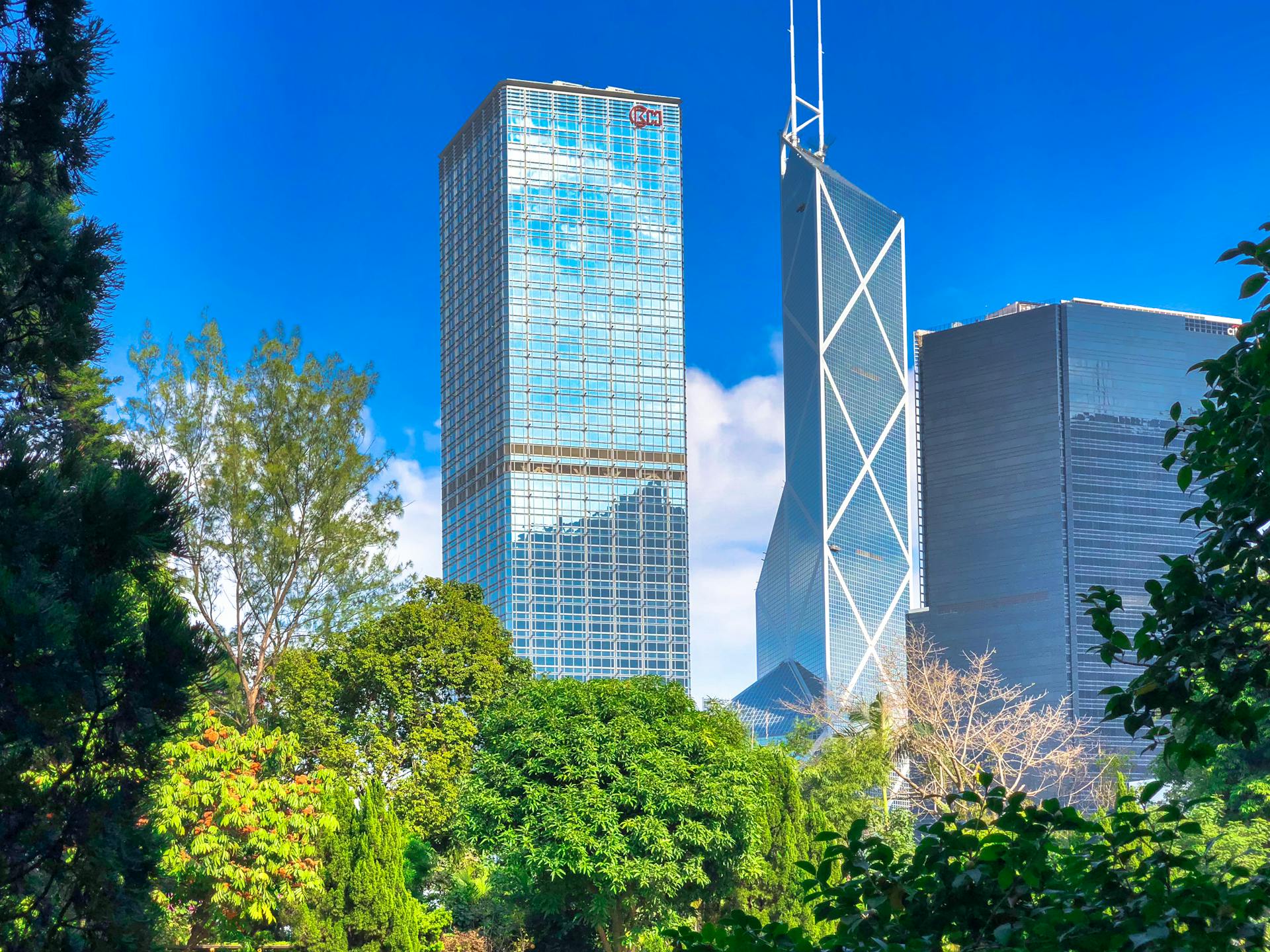 Stunning view of Hong Kong skyline featuring iconic skyscrapers amidst lush greenery.