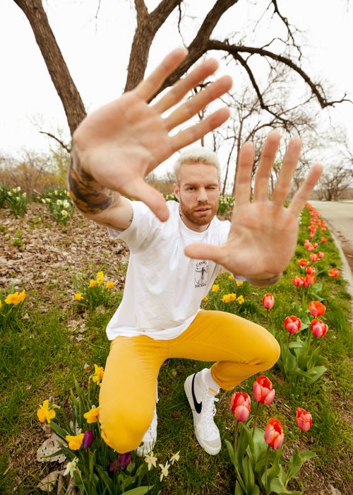 Free A man gestures in a spring park with colorful tulips in Des Moines, Iowa. Stock Photo