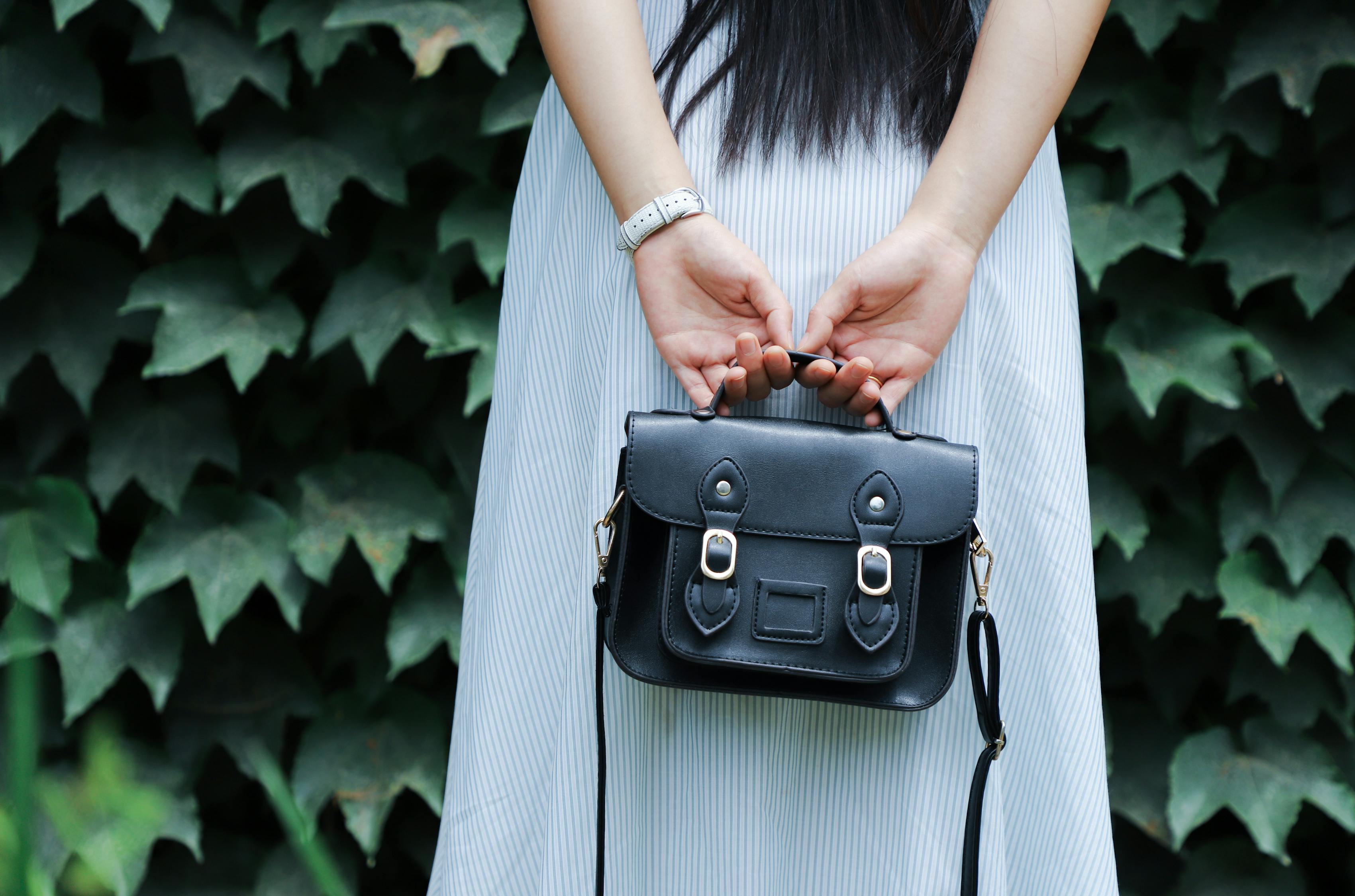 Woman Holding Black Leather Bag