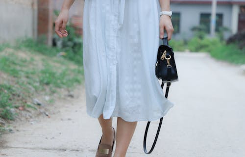 Woman Holding Black Leather Bag Walking on Road