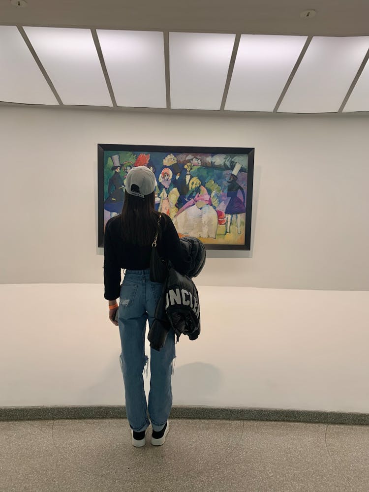 A Woman Admiring A Painting