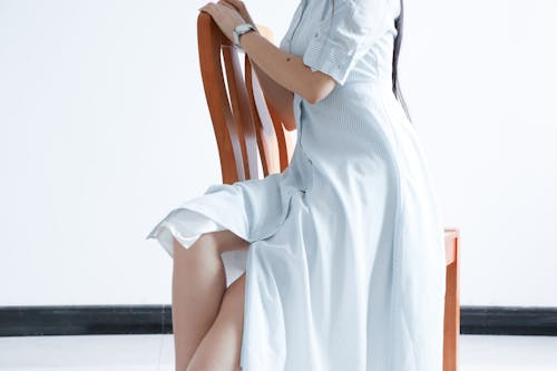 Woman Wearing Dress Sitting On Chair