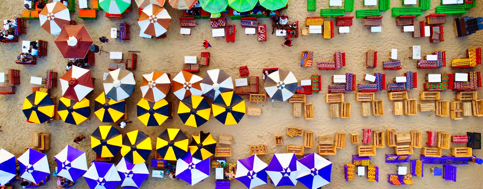 Vibrant aerial view of beach umbrellas and seating in Accra, Ghana.