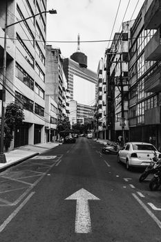 Monochrome photo of a street in Mexico City with view of office buildings.