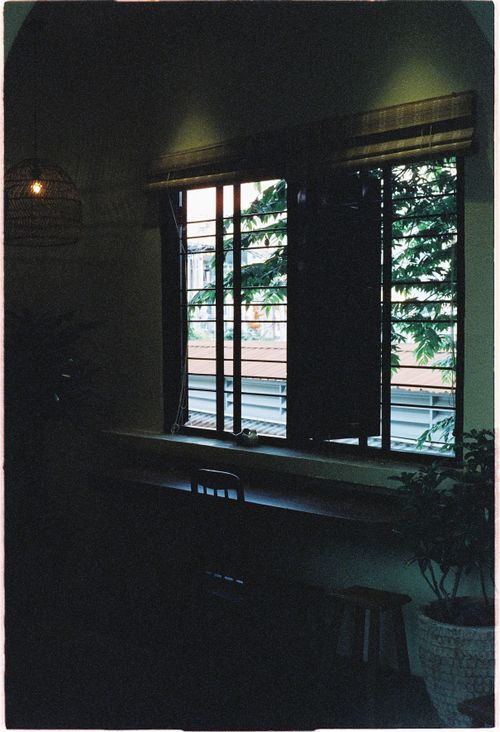 Free Serene interior view of a dark room with open window and potted plant, exuding a tranquil atmosphere. Stock Photo
