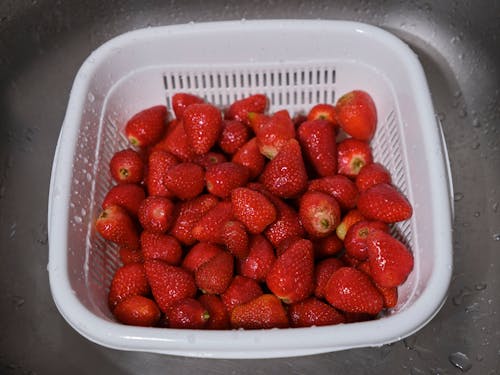 Close-Up Shot of Fresh Strawberries on White Plastic Tray