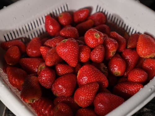 Close-Up Shot of Fresh Strawberries on White Plastic Tray