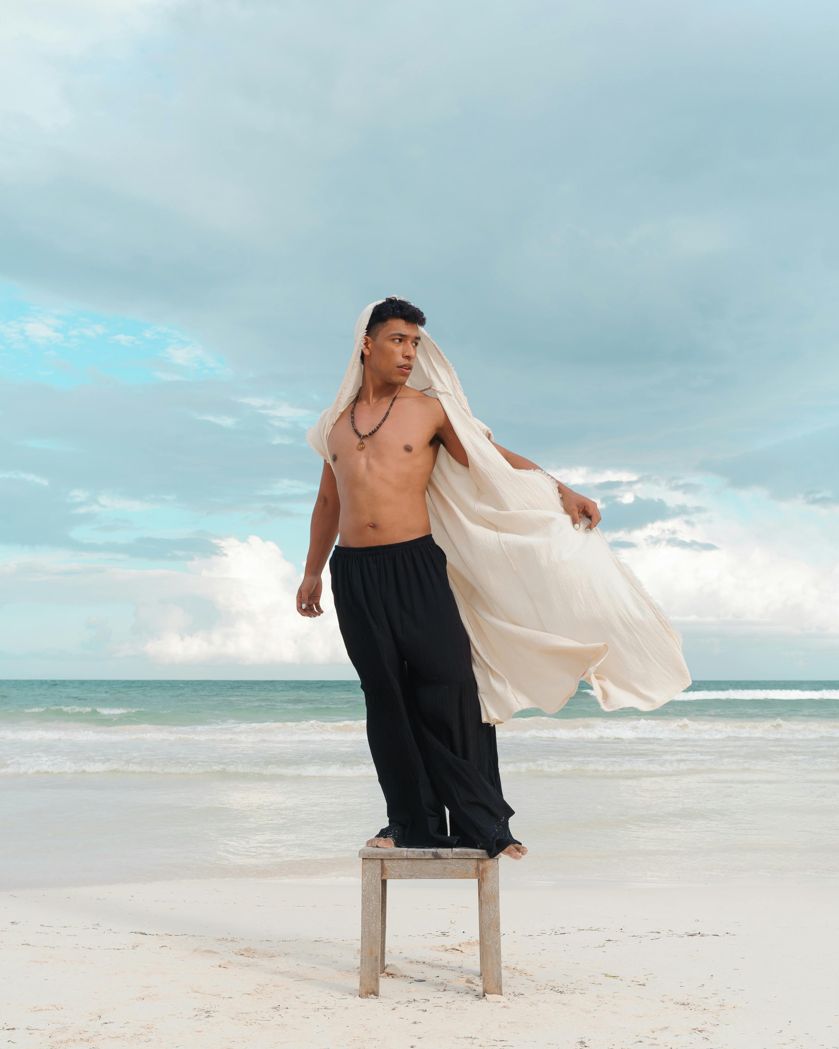 Portrait of handsome man posing at the beach Stock Photo by halayalex