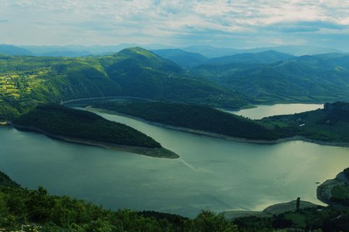 Free A breathtaking aerial shot of Zlatar Lake with lush green mountains in Serbia. Stock Photo