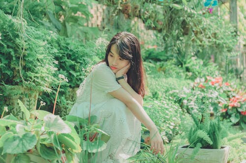 Woman Sit Squats in Garden