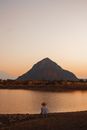 Man Looking at Lonely Mountain and River in Light of Rising Sun