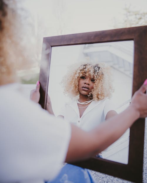 A Woman Looking at Her Reflection in the Mirror