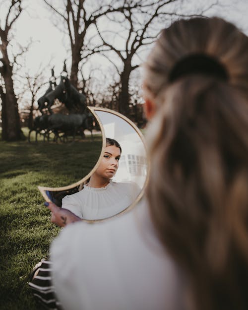 Woman Looking at her Reflection in a Mirror 