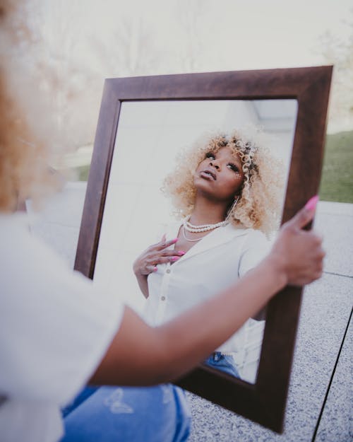 Woman Holding Mirror in Frame